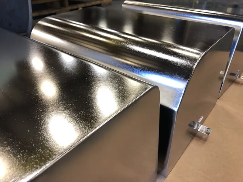 Mirror-finish stainless steel chute finished to reduce product adhesion at Harrison Electropolishing